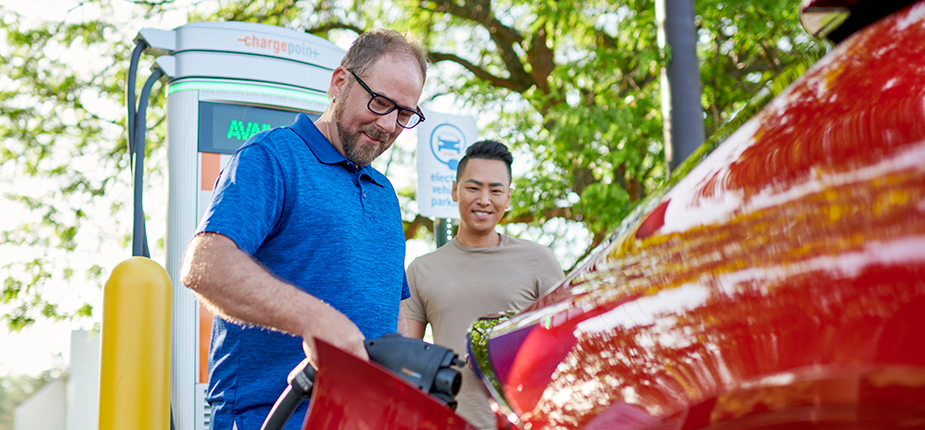 Drivers using a fast EV charger installed through the Consumers Energy PowerMIDrive charger rebate program